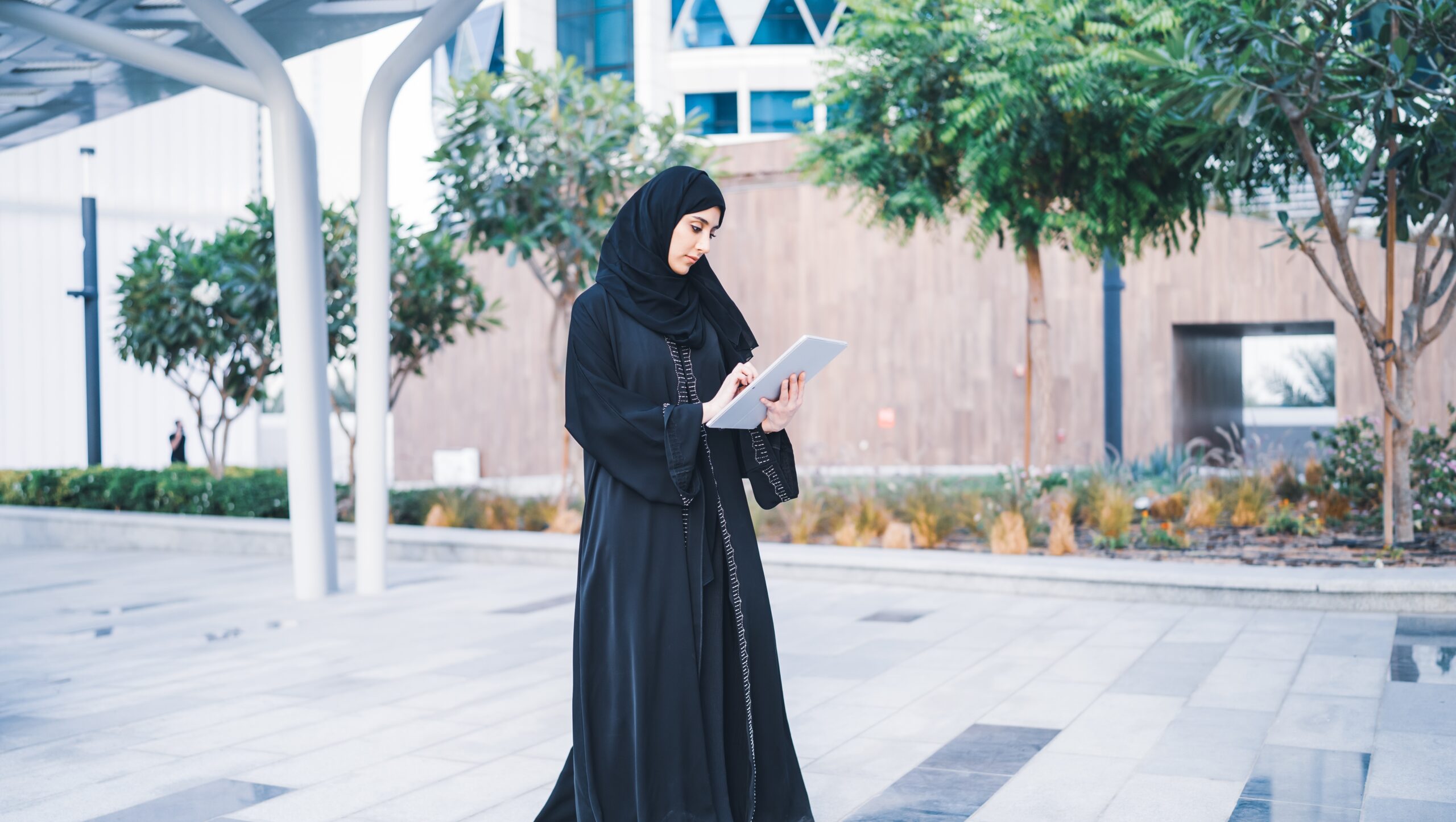 Arab,Muslim,Business,Woman,Working,On,Tablet,In,Outdoor,Meeting. Arab,Muslim,Business,Woman,Working,On,Tablet,In,Outdoor,Meeting.